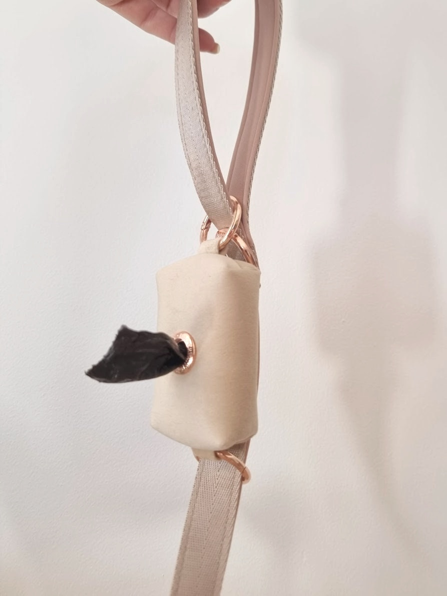 Beige dog leash and tidy poop bag holder