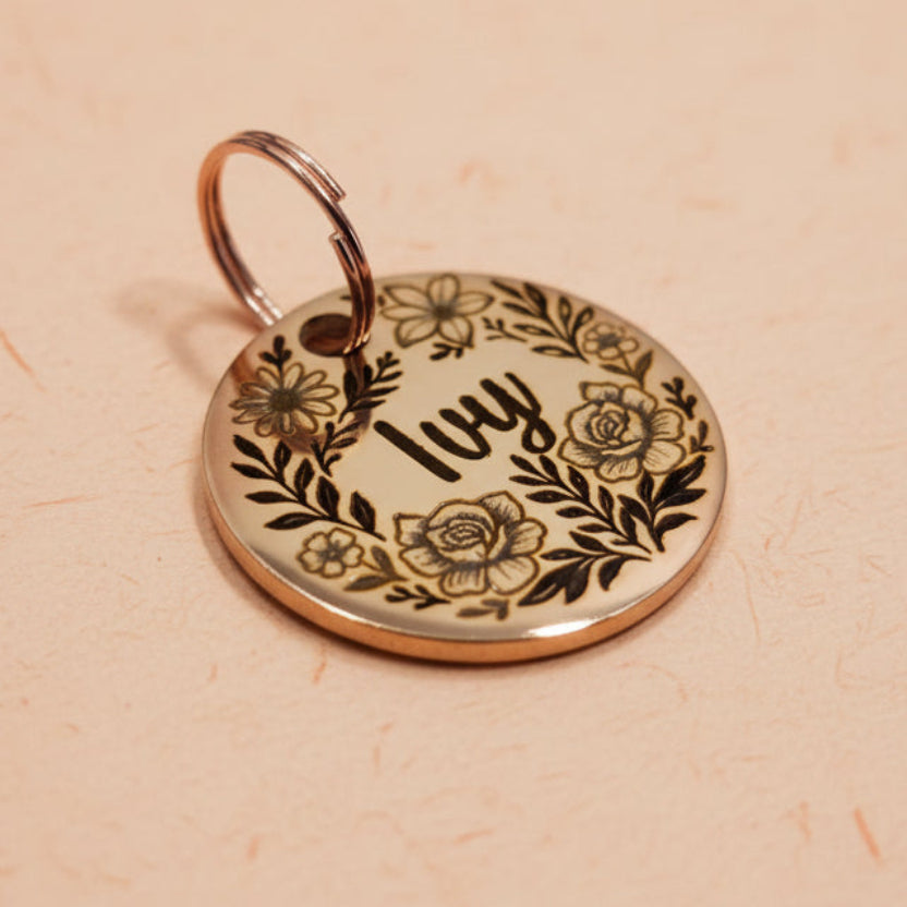 Round rose gold dog tag with floral design and engraved name